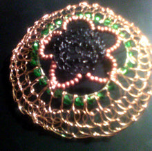 Load image into Gallery viewer, Black wire at the center, with a 5-petal flower made from copper beading forms the center of this handmade kippah. Emerald green crystals and copper wire form the outer circles.