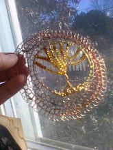 Load image into Gallery viewer, Beaded TOL beng held up to a window, wherein you can see an oak tree