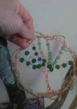 Load image into Gallery viewer, Copper, silver and gold wire wrapped tree of life being held on found  tree branch with natural growth on the found branch.