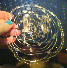 Load image into Gallery viewer, Teal and silver beaded wire kippah being held in front of computer