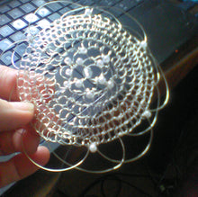 Load image into Gallery viewer, silver, pearl and crystal flower kippah being held in front of a computer
