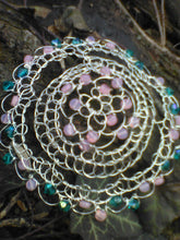 Load image into Gallery viewer, Teal and pink beaded silver wire kippah, displayed against a log