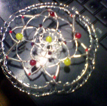Load image into Gallery viewer, Daffodil yellow and tulip inspired colors of Czech glass beads on  silver bugle beads and silver wireform this nature inspired kippah. Shown on a computer keyboard.
