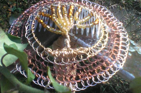 Closeup view of the beaded wire TOL kippah with fuzzy peach, gold and amber beading