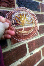 Load image into Gallery viewer, Another picture of the kippah n the mornng light, held against a brick wall.

