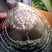 Load image into Gallery viewer, Crystal and Silver TOL Kippah held against white statue with an envelope and a lamp in the background
