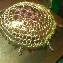 Load image into Gallery viewer, Sprng Colors Purple and green beaded kippah with purple dangles resting on brown table. There are file folders in the background.
