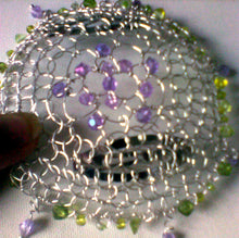 Load image into Gallery viewer, Spring Colors Kippah: purple and gren crystals and seed beads on silver wire crochet. Two clips are attached to the underside of the piece. Purpcle crystals dangle from various places around the perimeter of the kippah.
