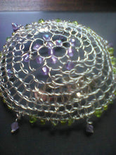 Load image into Gallery viewer, Spring color of purple and green on silver wire crochet kippah. The kippah is shown on a closed laptop computer.
