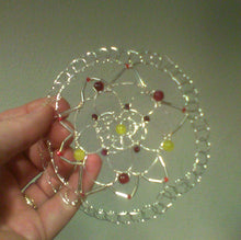 Load image into Gallery viewer, Edgy doily shaped kippah  made from silver wire  silver bugle beads, Czech glass beads in tulip and dafodil calors. The kippah is being held against a gray background.
