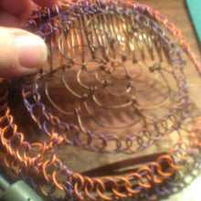 Load image into Gallery viewer, Brown, purple and orange coated copper wire is repurposed for a kippah 
