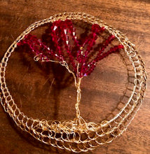Load image into Gallery viewer, Tree of Life head covering made from gold wire and red crystals. Shown on a wooden surface.

