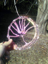 Load image into Gallery viewer, A hand holds the kippah against the branch of a live tree in January
