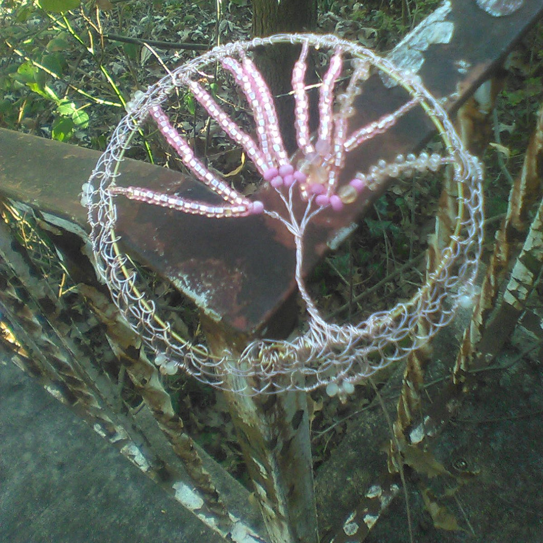 Shkeyiah TOL Kippah on a peeling railing. A live tree trunk and green vines are in the background.