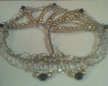 Load image into Gallery viewer, This TOL kippah is made from silver and gold wire and repurposed black and gold beads.
