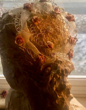 Load image into Gallery viewer, Winter Rose Kippah shone on back of stone bust. Snow  backlights the scene.
