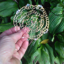 Load image into Gallery viewer, Beaded gold wire kippah against green leaves
