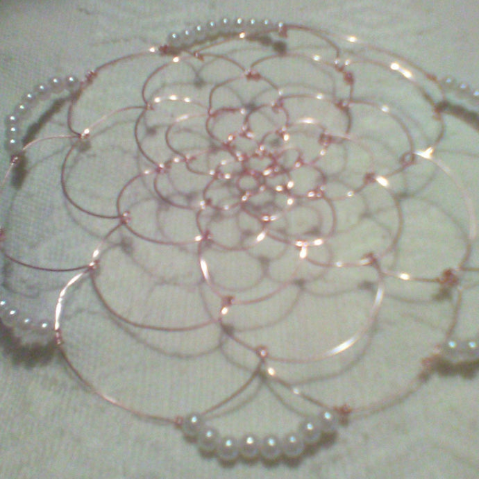 Rose gold and pearl kippah on white backgroundd