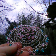 Load image into Gallery viewer, Teal and pink beaded silver wire kippah being held in hand
