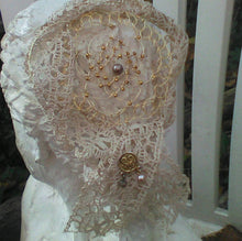 Load image into Gallery viewer, Back view of vintage lace and gold wire kippah on sculpture
